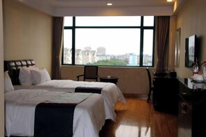 A hotel room with two beds, a desk, a chair, a television, and a large window with a city view. - Shenhang Yinju Mingzhu Hotel (Jiashan)
