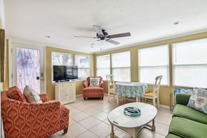 Enjoy a spacious room with a large window, television, and comfortable sofa.
