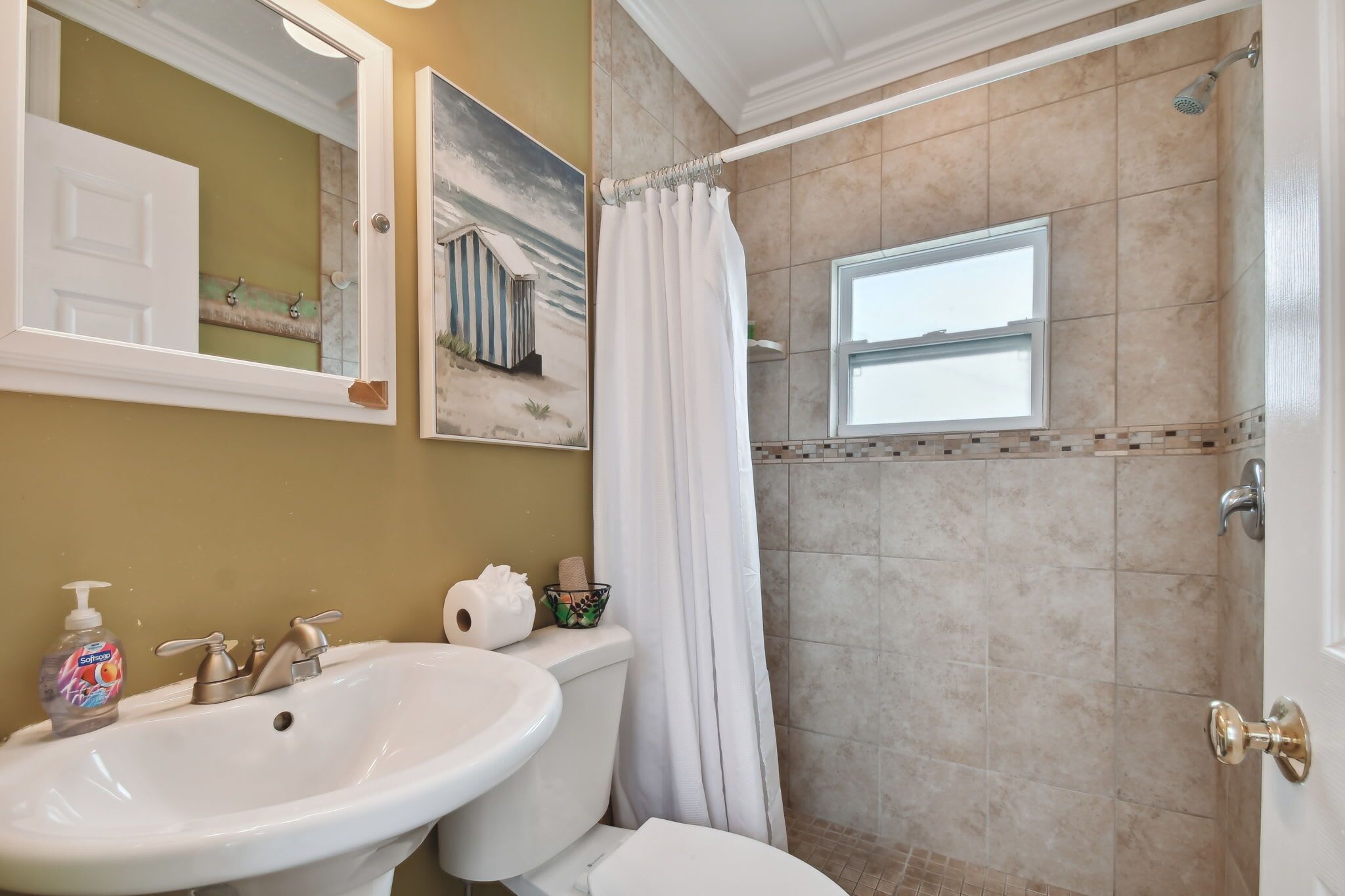 A bathroom with a sink, toilet, and shower.