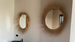A bathroom with two stone sinks, a wooden vanity, and two wall-mounted mirrors with decorative frames. - Villa Bamboa – Ibiza-Styled Tropical Escape Near Jan Thiel Beach (Jan Thiel)