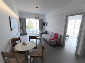 Apartment, 1 Bedroom, Partial Sea View | 1 bedroom, in-room safe, individually decorated, individually furnished