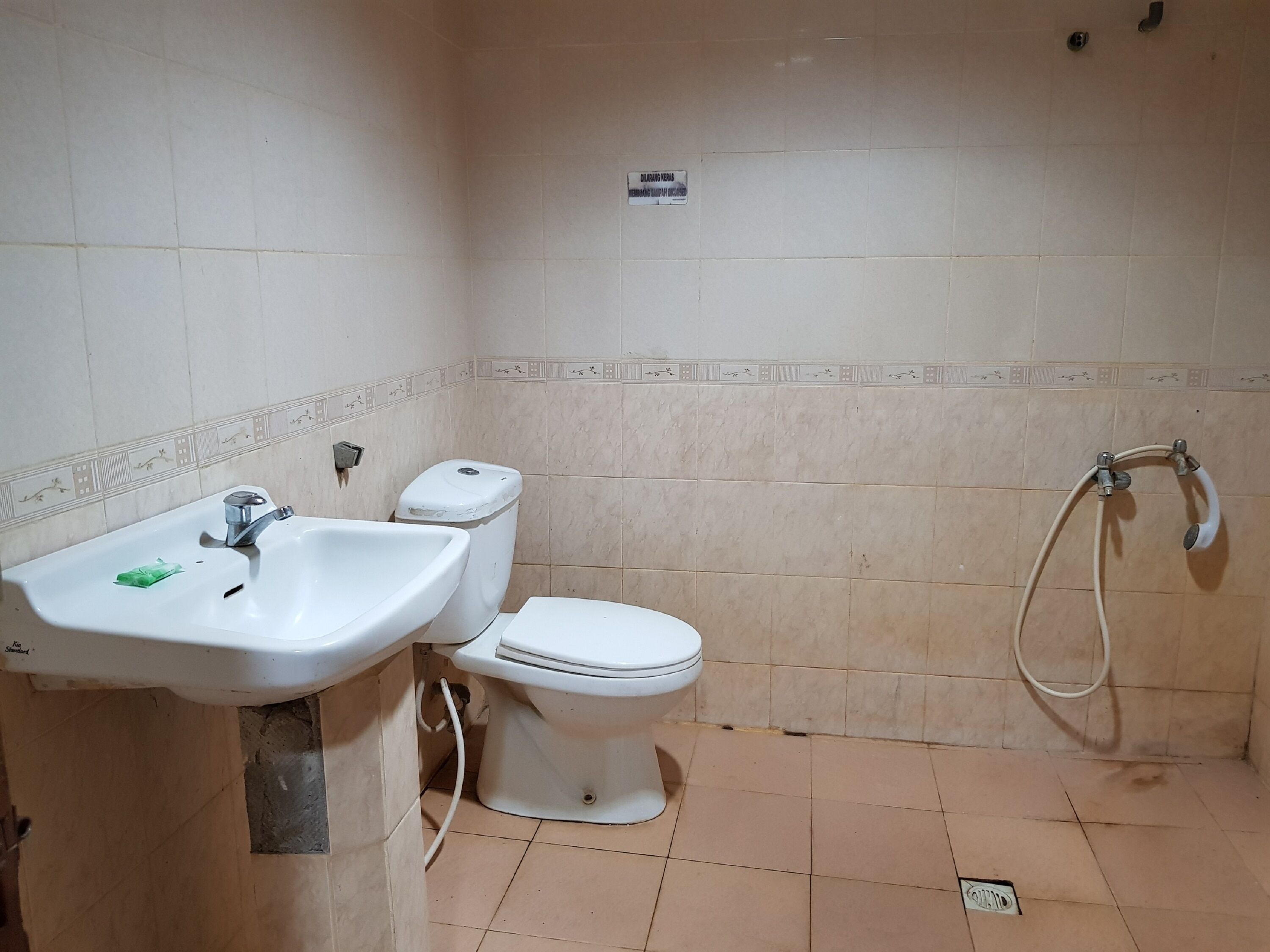A bathroom with a sink, toilet, and shower.
