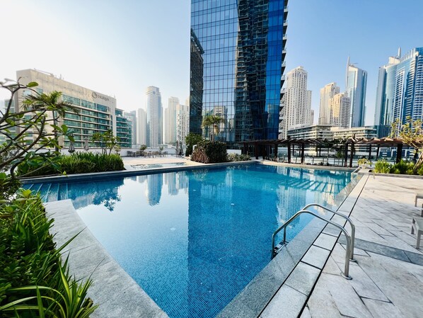 A rooftop pool with a clear view of surrounding high-rise buildings.