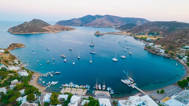 A coastal marina with boats docked, surrounded by hills and a small town. - Apartment In A Hotel 'Pico Bello Patmos 22' with Mountain View, Wi-Fi and Air Conditioning (Patmos)