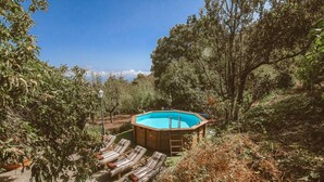 A hot tub surrounded by lounge chairs in a garden setting. - Country House in Gran Canaria with Private Pool (San Mateo)
