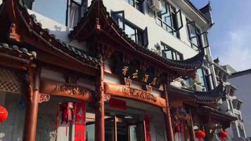 A traditional building with a prominent entrance, large windows, and decorative elements.