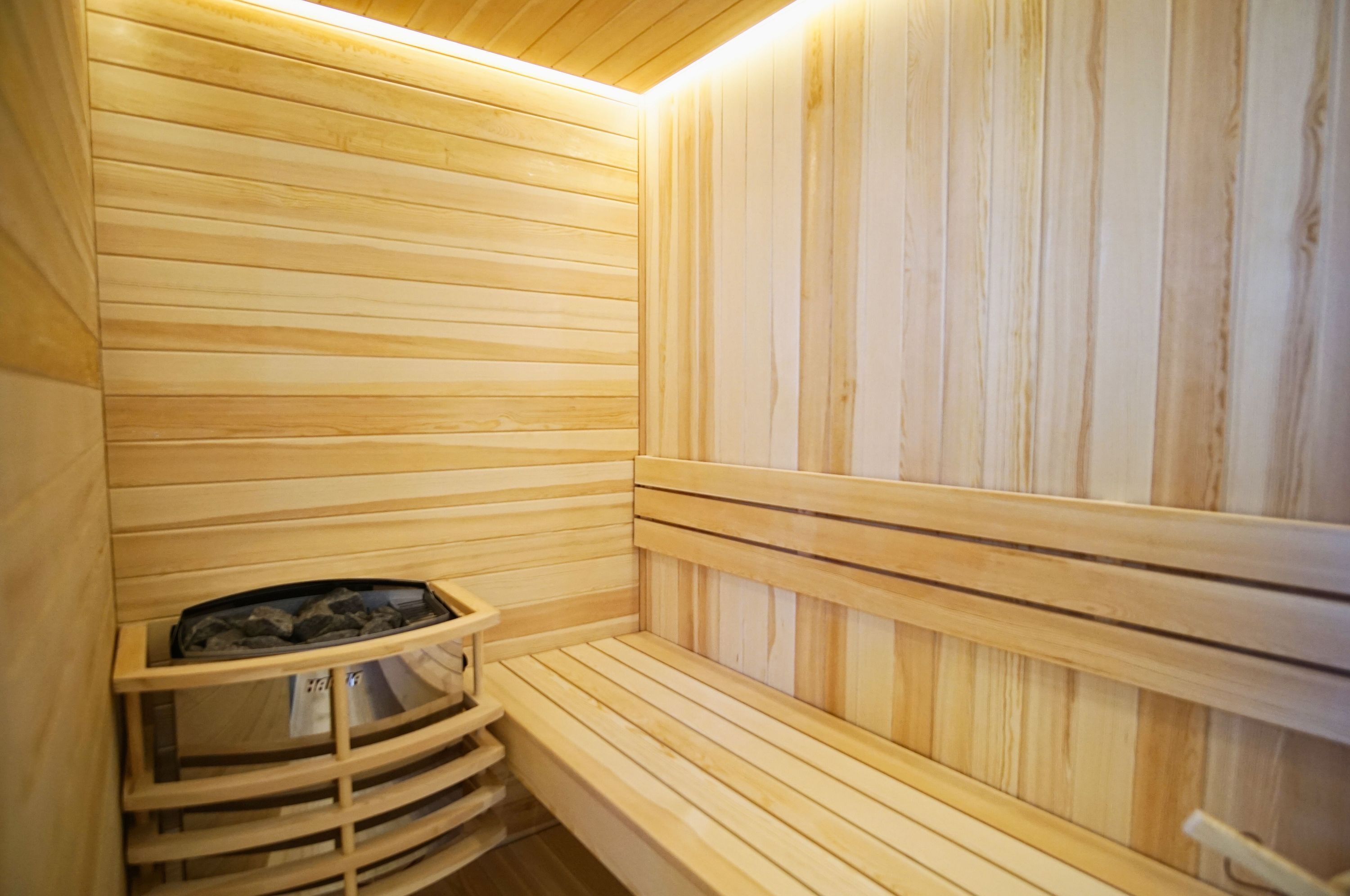 A sauna with wooden benches and a built-in bench seat.