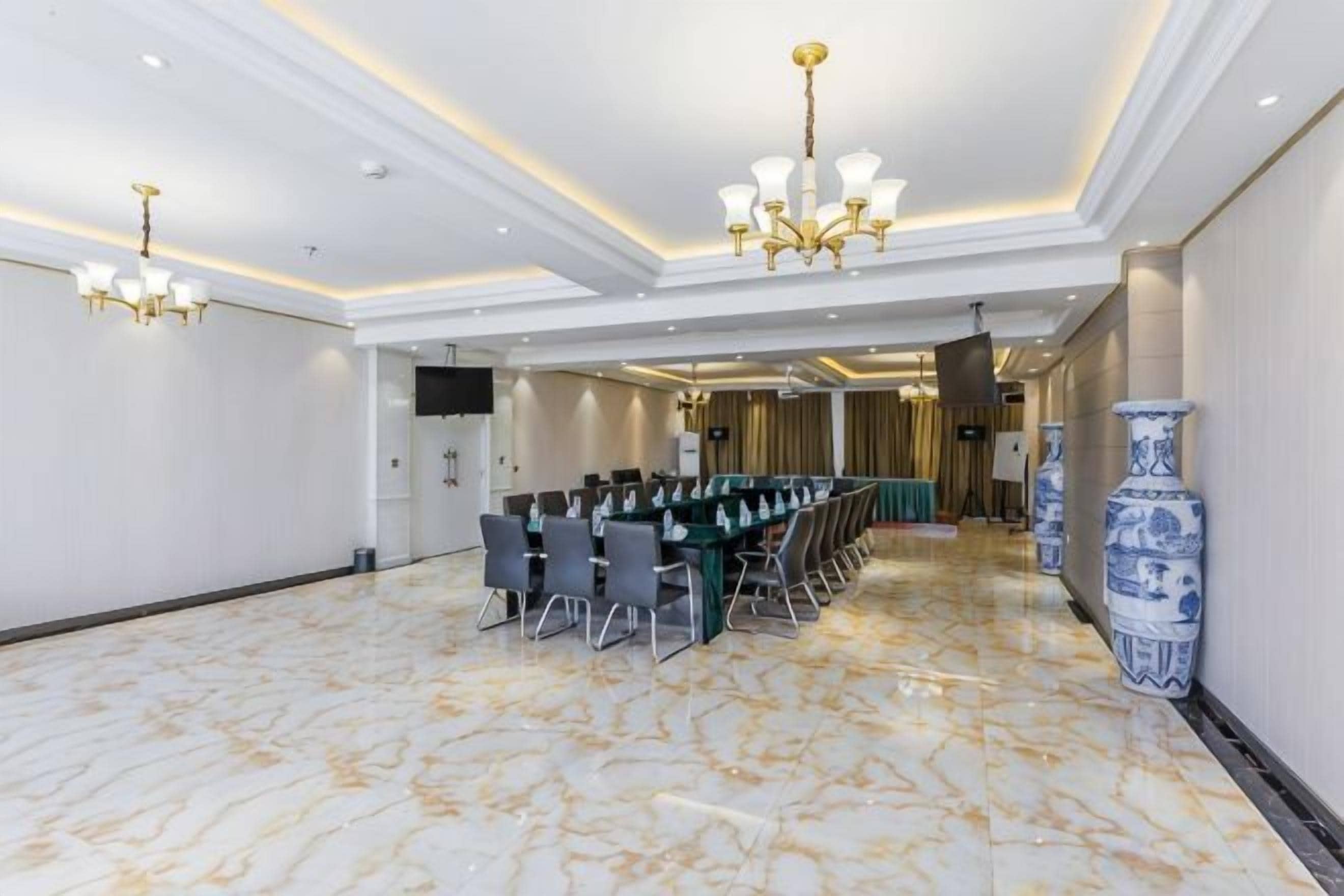 A conference room with a long table, chairs, and a chandelier.