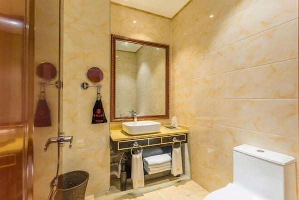 A bathroom with a sink, mirror, towel rack, and toilet.