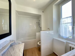 Shower, hair dryer, towels, toilet paper