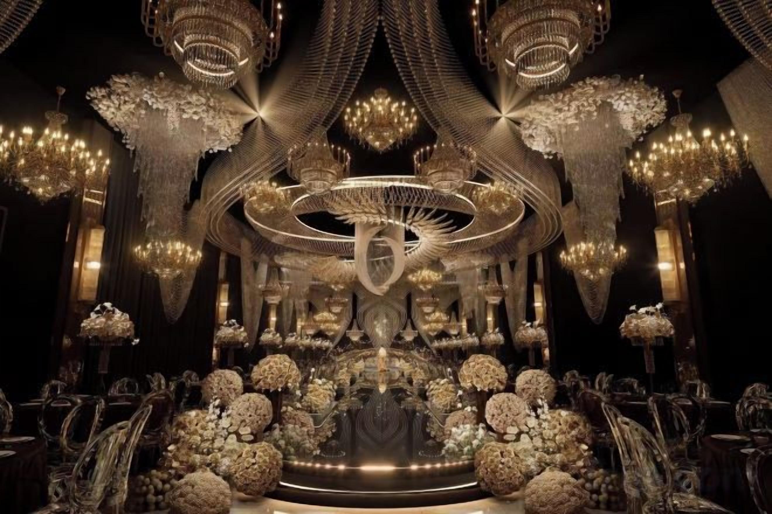 An opulent interior with chandeliers, ornate decorations, and a central circular structure.