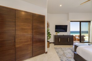 Enjoy ocean views from the comfort of your room, featuring a large bed and a flat-screen TV.