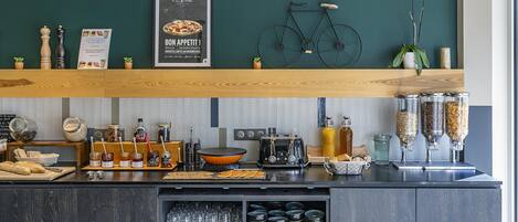 A kitchen counter with various food items, jars, and a bicycle decoration.