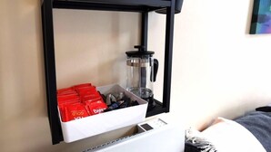 A shelf with a coffee maker, a jar, and red packets. - Great Central Location 1BED APT Off OConnell ST (Dublin 1)