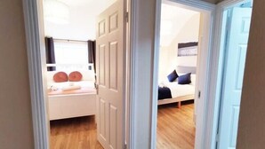 A bedroom with a bed, a nightstand, and a window. - Great new 2bed apartment in city centre*fast WIFI (Dublin 1)