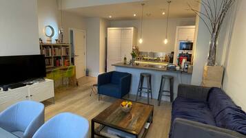 Basic Apartment, Multiple Beds | Living area | TV