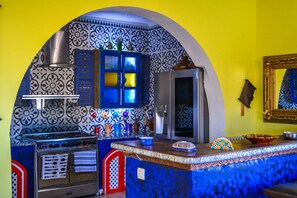 A kitchen with a stove, oven, and blue cabinets. - Villa: Oceanfront, 5 Beds, Pool & Beach Access (Mirleft)