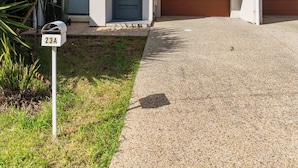A modern two-story residential building with a front garage, a mailbox, and a small garden area. - Mellow&Modernized Townhouse-3Beds-Quiet-Anzac Hwy (Plympton)