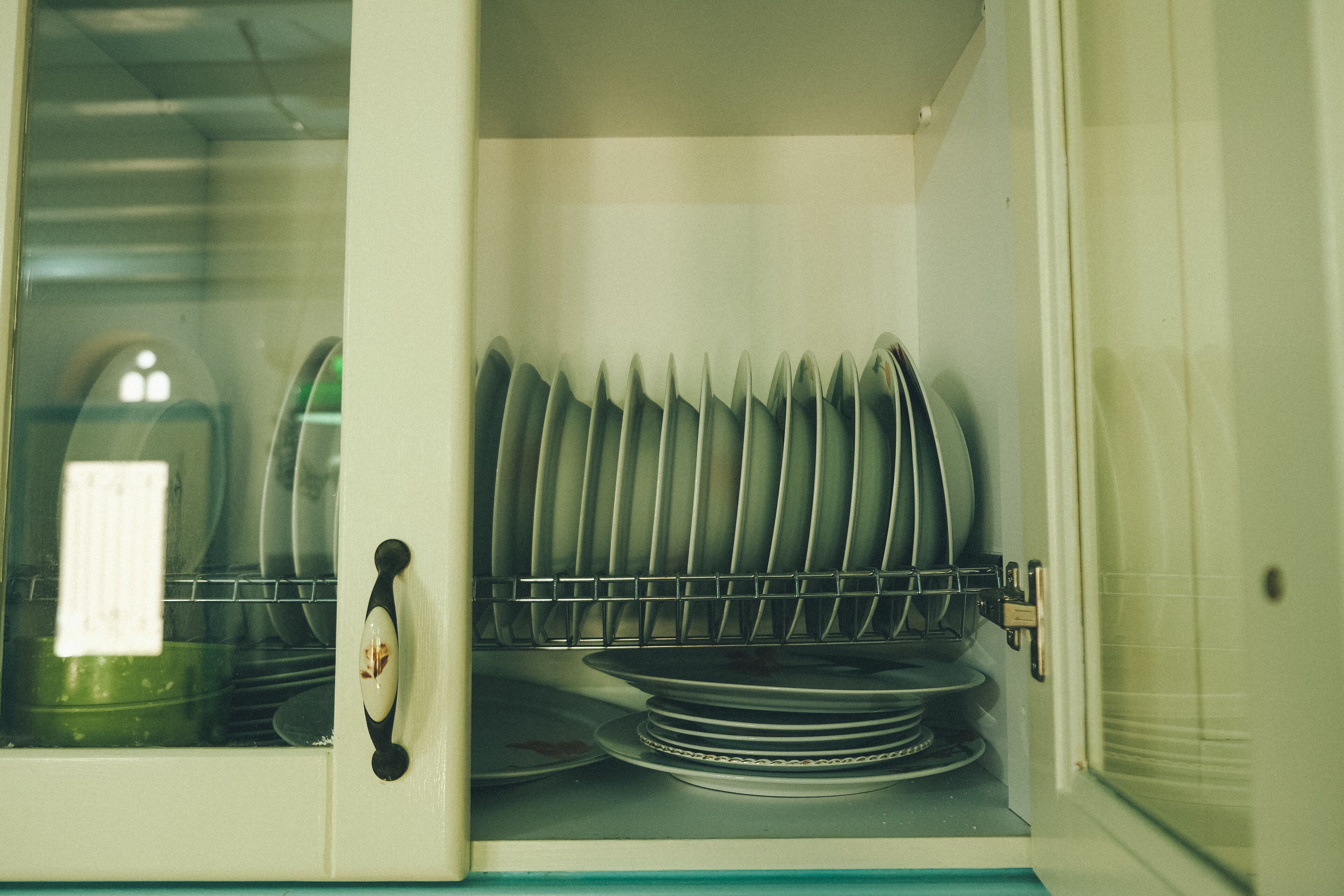 A dishwasher with stacked plates and a glass door.