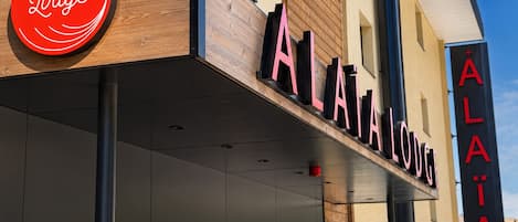 A building with a prominent sign reading 'ALAIA Lodge'.