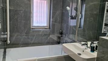 A modern bathroom with a bathtub, a sink, and a toilet.