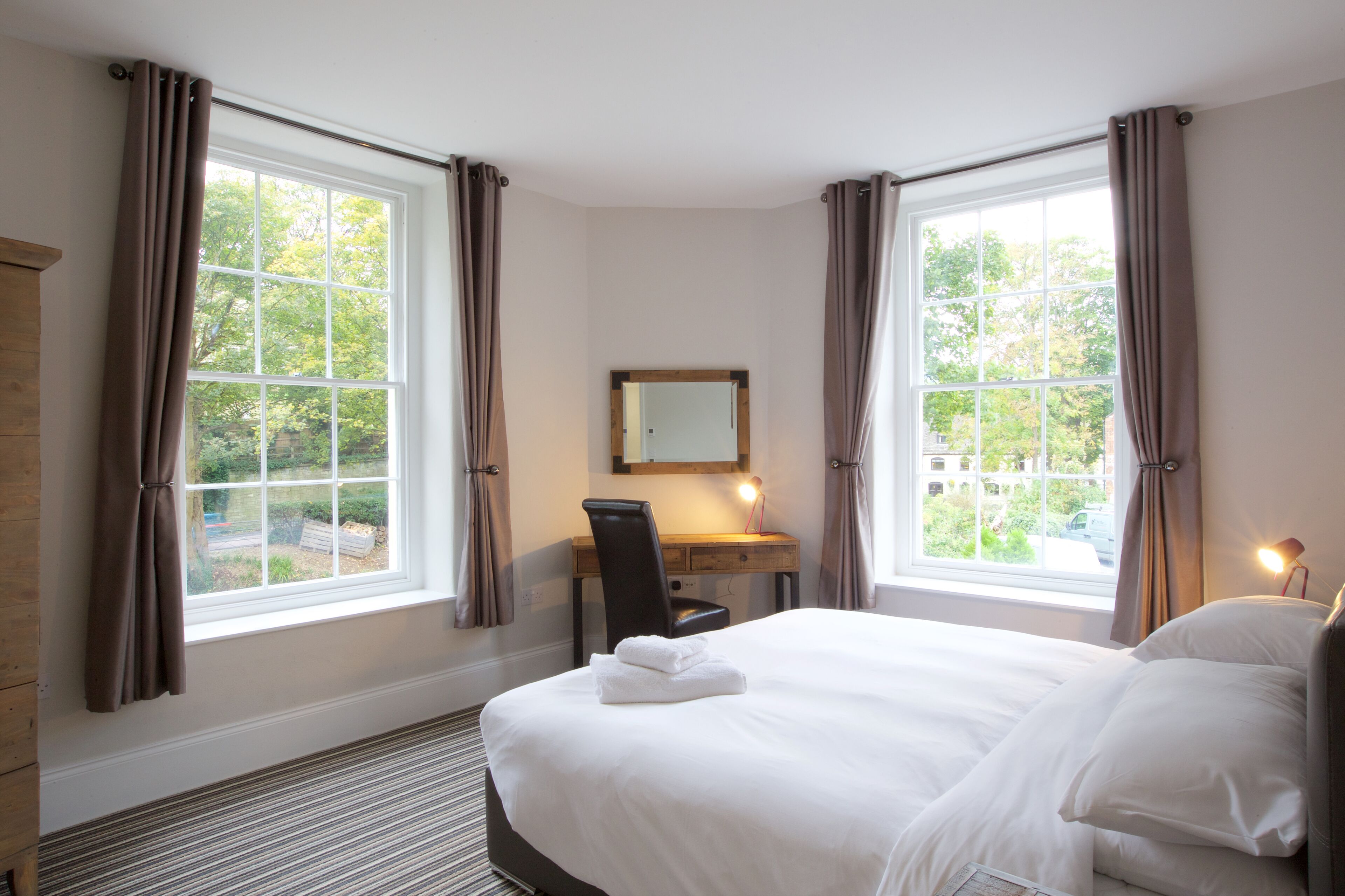 Premium bedding, memory-foam beds, desk, laptop workspace