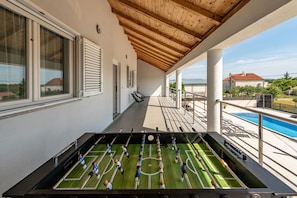 Relax by the pool or challenge friends to a game of foosball in this outdoor leisure space.