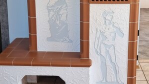 Una chimenea con textura de piedra y un adorno en la parte superior.