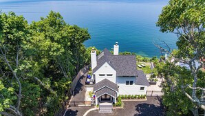 A house with a driveway, a garage, and a small porch. - Coastal Retreat Waterfront, Deck, Awesome Views (Wading River)