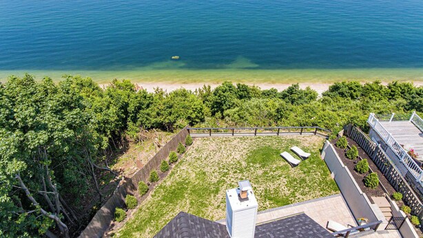 An aerial view of a beachfront property with a wooden deck, a small boat, and a clear view of the ocean. - Coastal Retreat Waterfront, Deck, Awesome Views (Wading River)