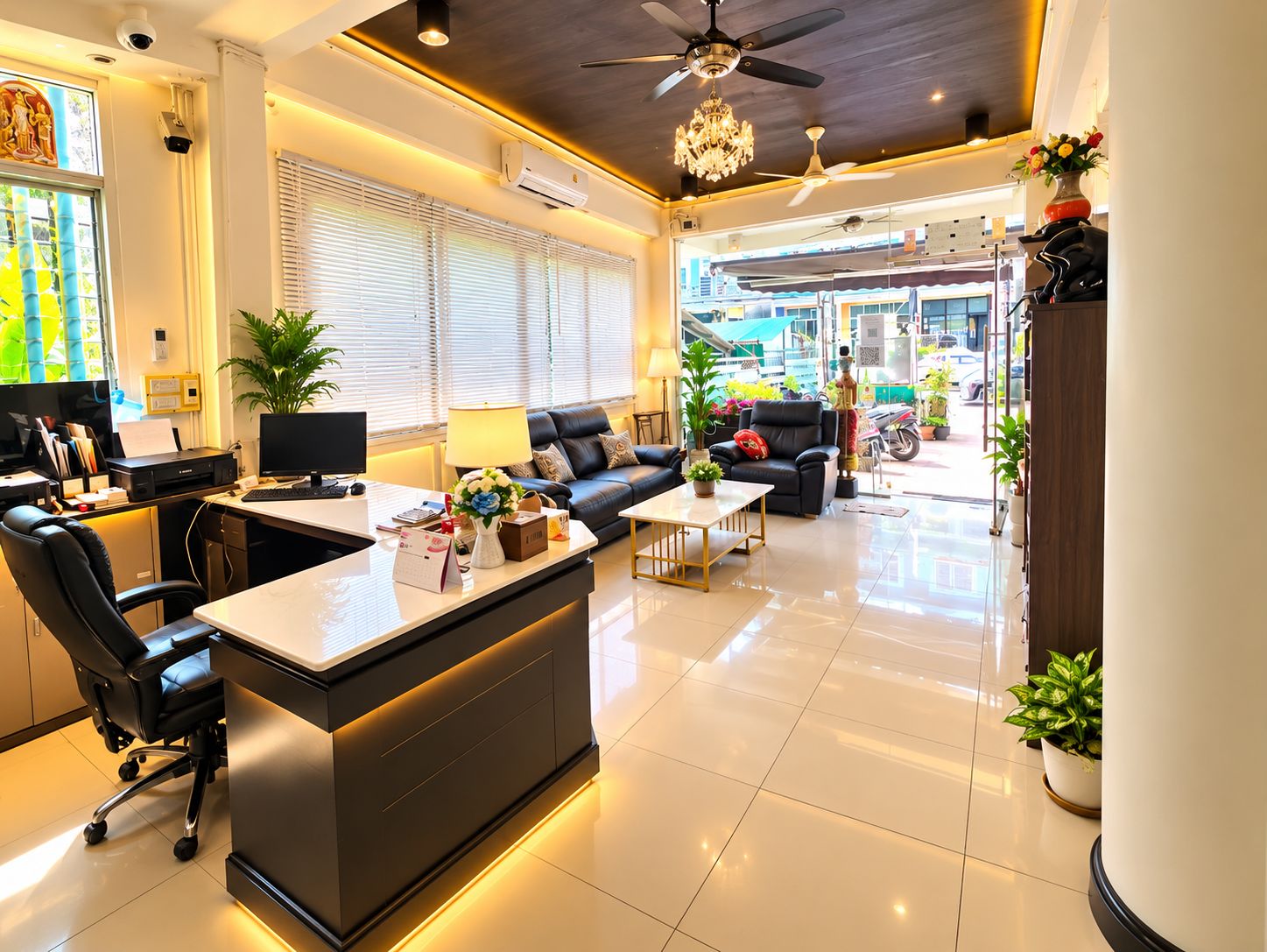 A modern hotel lobby with a reception desk, seating area, and large windows.