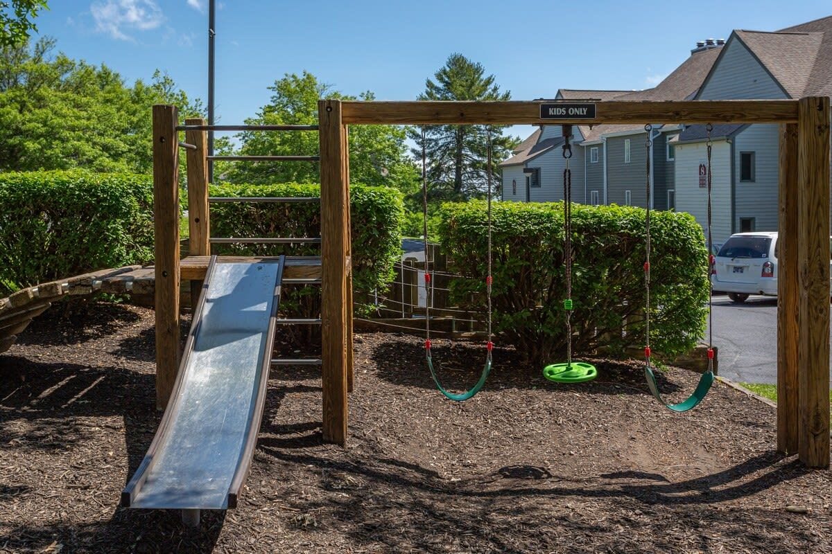 A playground with a slide, swings, and a 'MIDS ONLY' sign.