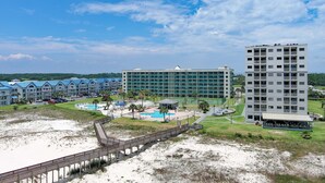 A resort with multiple buildings, a beach, and a pool area. - Beach Please 2BR Gulf Shores Oceanfront/Pool, Beach Please Beachfront condo sleeps 6 (Baldwin County)