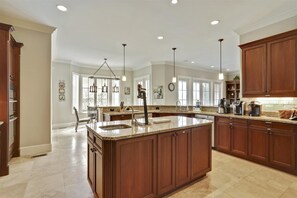 Enjoy cooking in this well-equipped kitchen with a large central island and ample counter space.