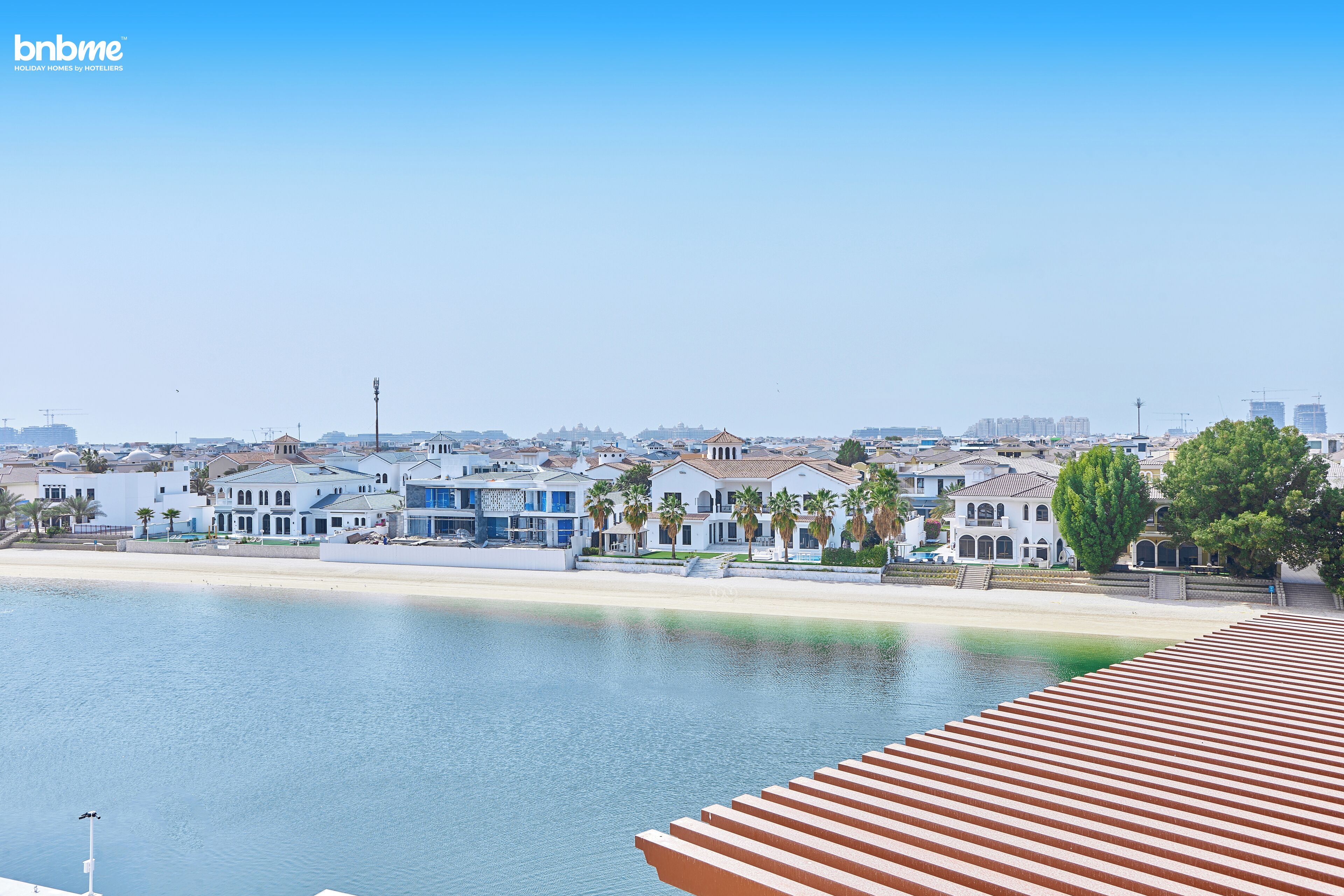Un hôtel situé sur la côte, offrant une vue sur la plage et le paysage urbain.