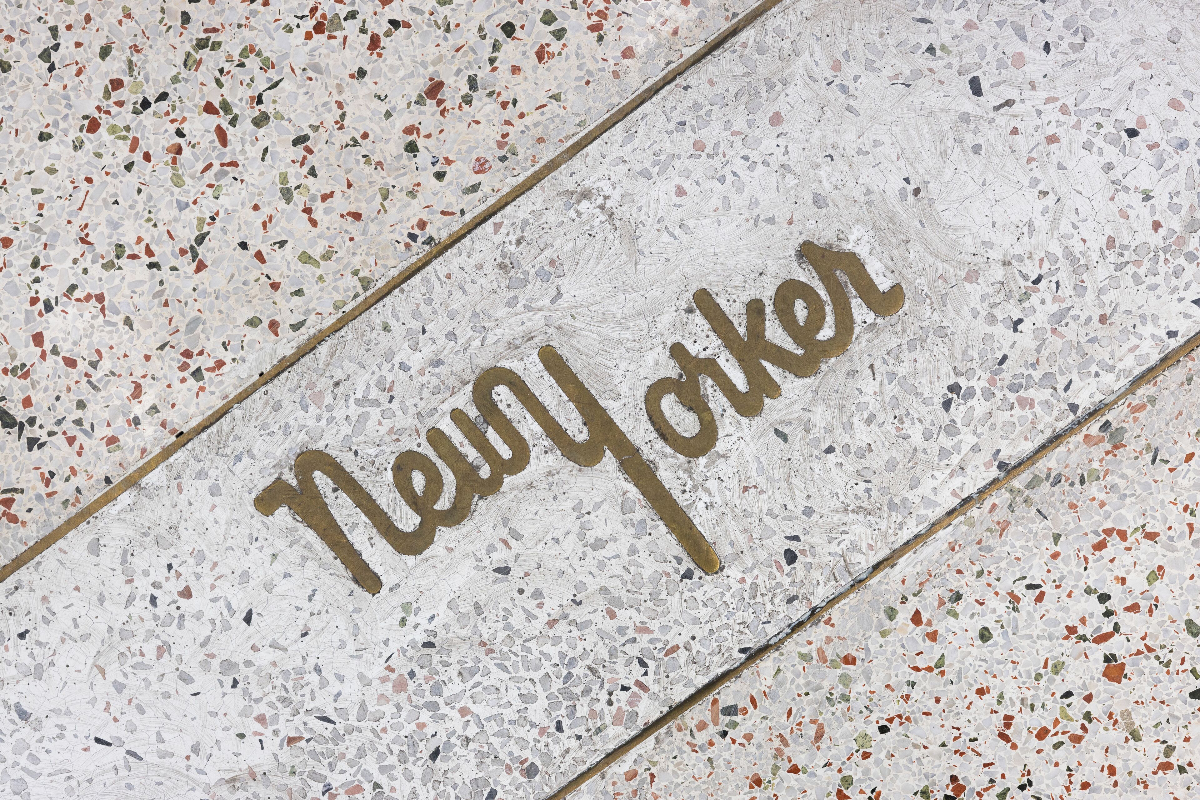A terrazzo floor with the words "New York" written in gold lettering.
