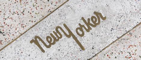 A terrazzo floor with the words "New York" written in gold lettering.