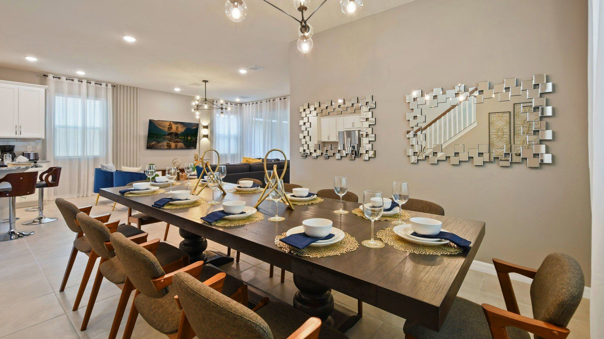 A modern dining room with a long table set for six, surrounded by chairs.