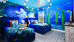 A room with two beds, a desk, and a mural of an underwater scene. - Last Minute Disney! Private Pool, Hot Tub, Game Room & Themed Bedrooms. Book Now! #87159 (Orlando)