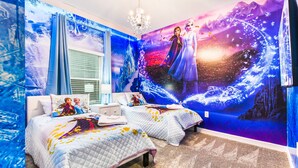 A bedroom with two beds, a chandelier, and a large wall mural of a winter scene. - Last Minute Disney Getaway! Private Pool & Themed Bedrooms. Book Now! #87193 (Orlando)