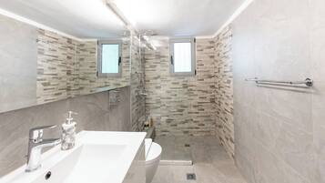 Shower, hair dryer, slippers, towels