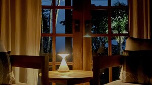 A dimly lit room with a table and two chairs, a window with curtains, and a view of trees outside. - A Remote Paradise in nature - Villa - Ocean View (Pedasi)