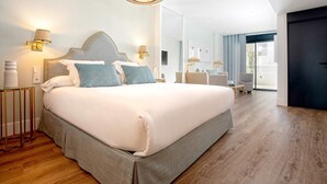 A modern hotel room with a large bed, bedside lamps, and a view of the outdoors. - Genteel Home Betis XXVI (Seville)
