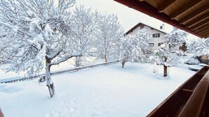 A snow-covered garden with trees and a house in the background. - 87452 Altusried district Frauenzell, near Center Parcs Leutkirch im Allgäu (Altusried)