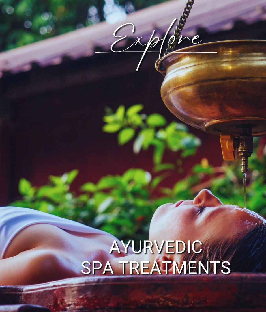 A person receiving an Ayurvedic spa treatment with a brass vessel hanging above.