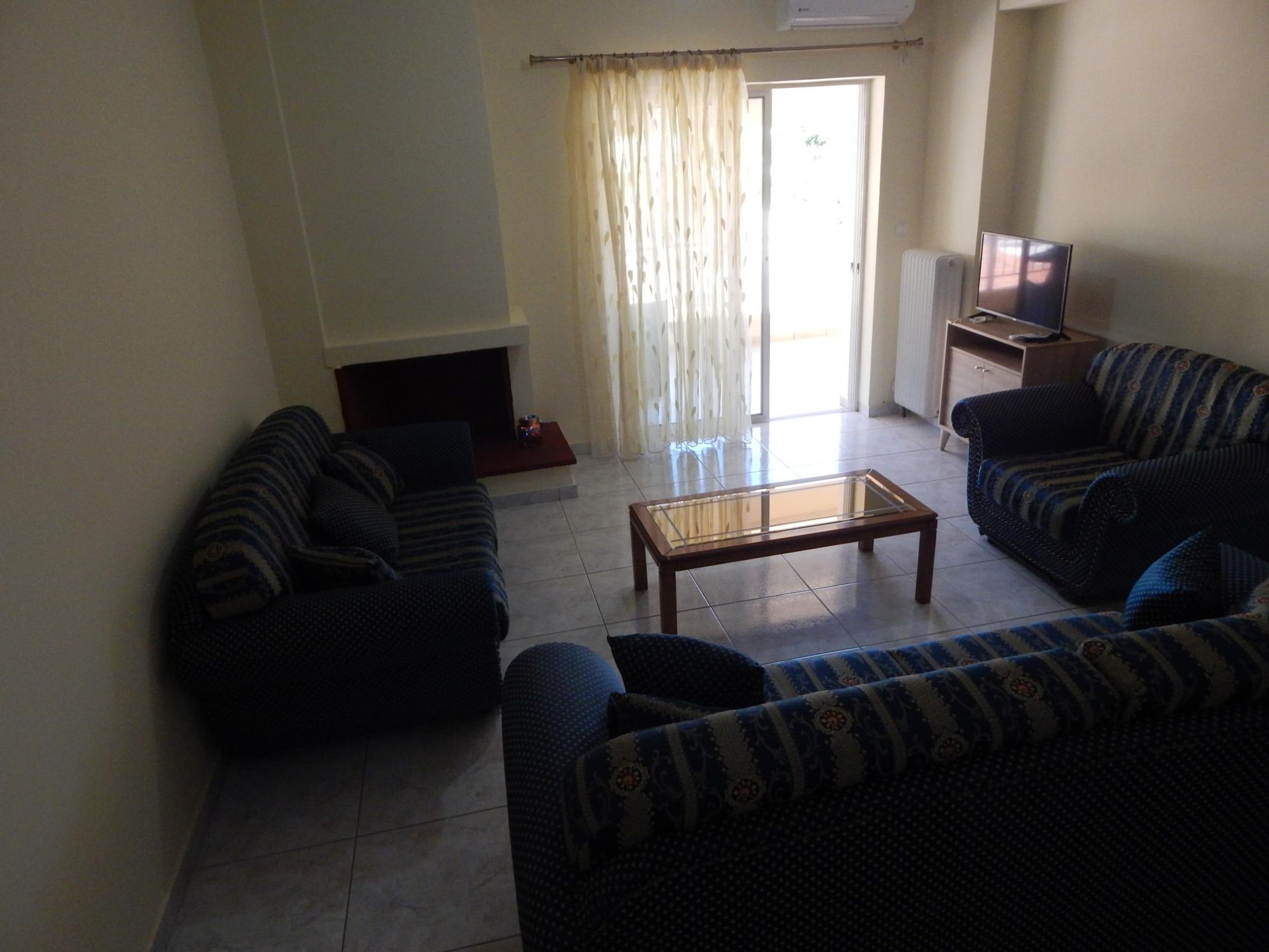 A living room with two sofas, a coffee table, and a fireplace.