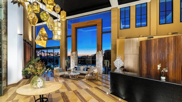A spacious lobby with a checkered floor, a reception desk, and a seating area with sofas and chairs. - Krystal Grand Residences San Miguel de Allende (San Miguel de Allende)
