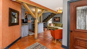 A spacious living area with a kitchen, a staircase, and a cozy seating area. - Luxury Barn with Best View in the Cuyahoga National Park.   (Peninsula)