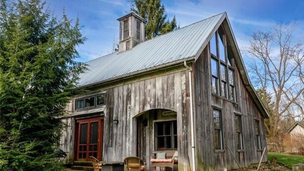 A rustic wooden house with a large front porch, a chimney, and a garage. - Luxury Barn with Best View in the Cuyahoga National Park.   (Peninsula)