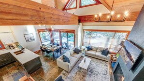 A spacious living area with a fireplace, a dining area, and a kitchen.